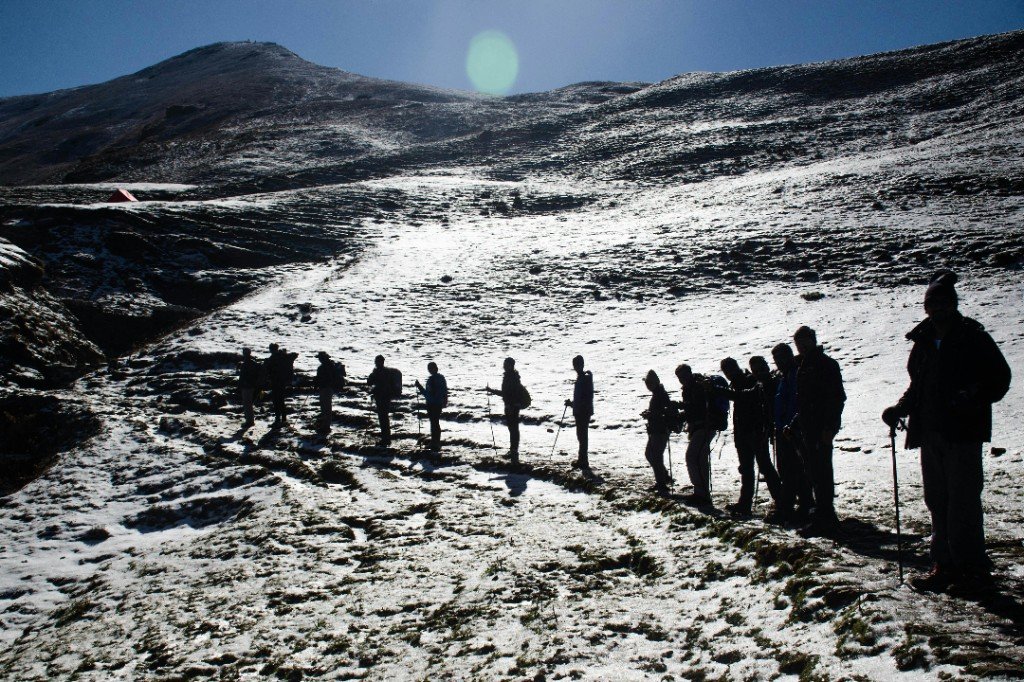Aerial view of Mount Kilimanjaro’s snow cap and crater rim rising above cloud